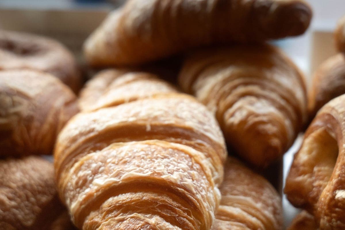 A pile of golden homemade butter croissants with crisp, flaky layers